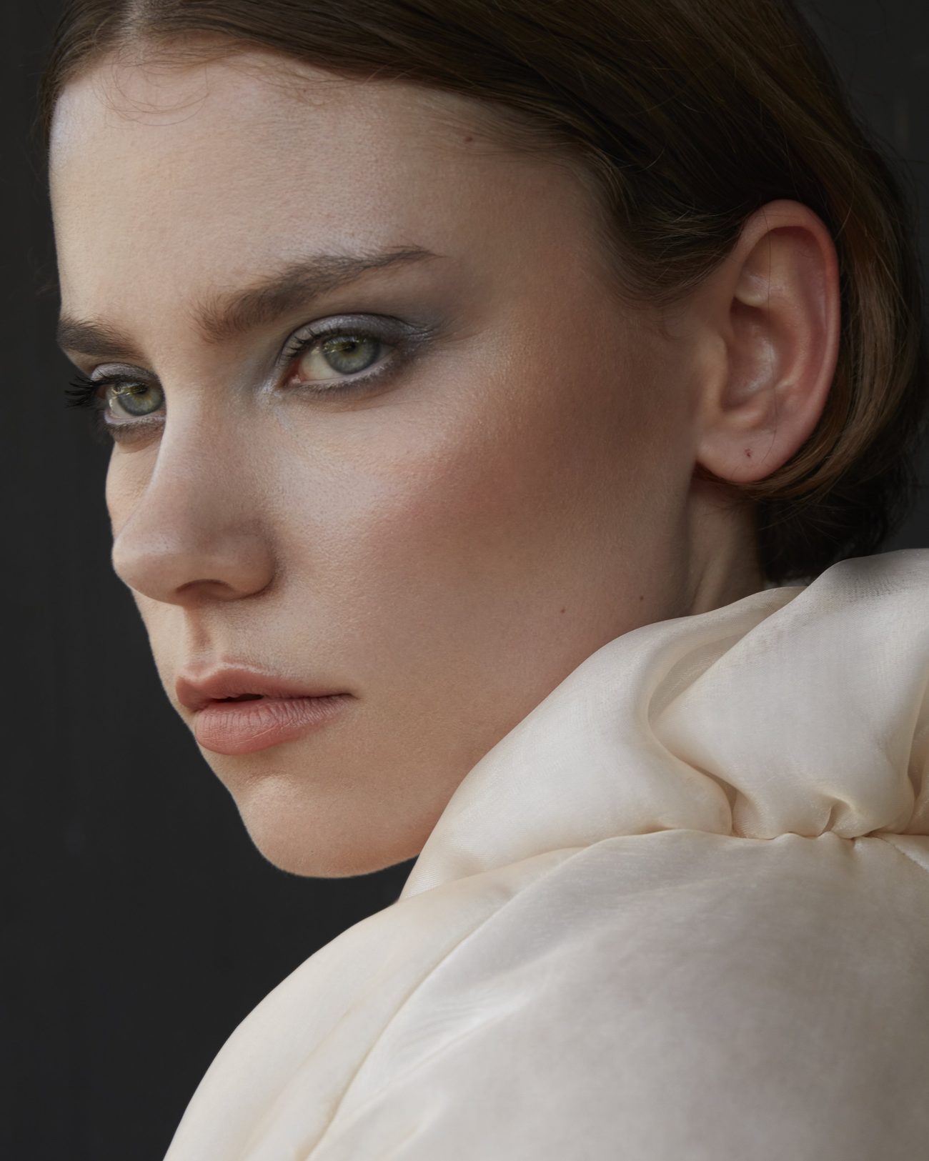 Portrait over the shoulder, soft grey eye shadow, cream organza collar