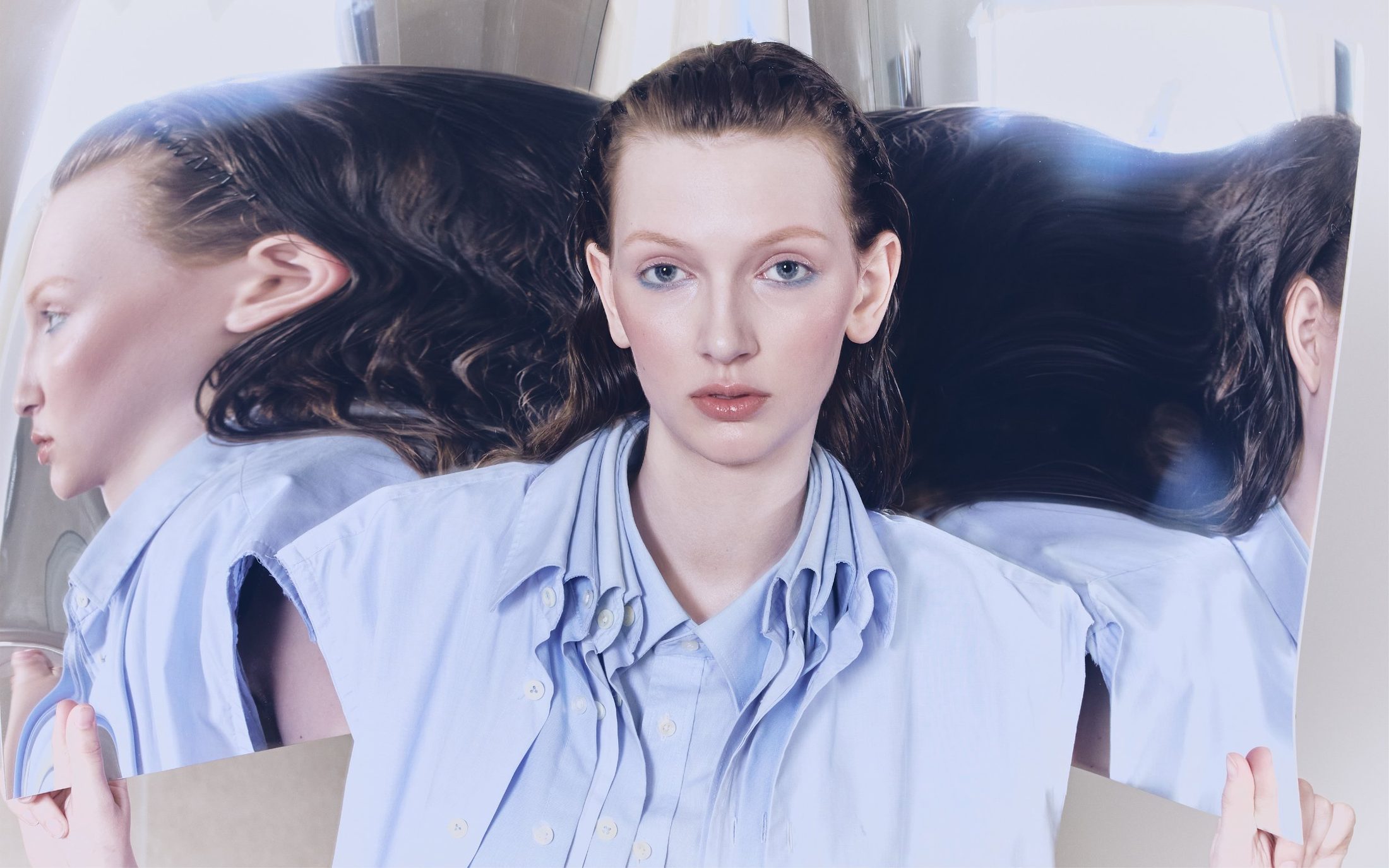 Magazine spread: a model in a pale blue shirt, mirrored three times
