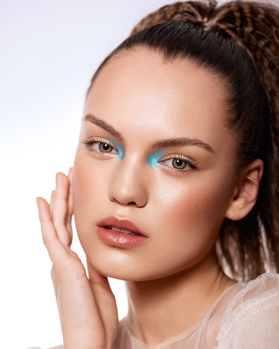 Beauty portrait with turquoise at the inner corners of the eyes